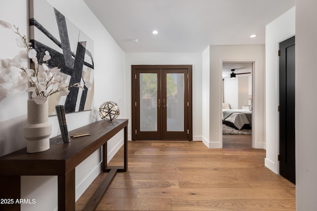 doorway featuring recessed lighting, baseboards, french doors, and light wood finished floors