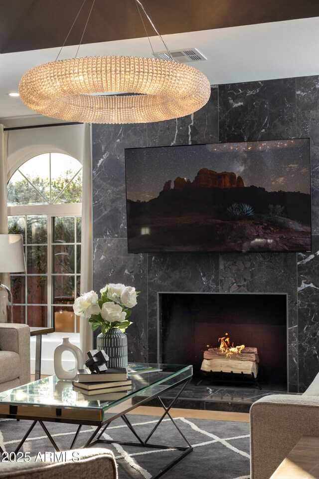 living room with visible vents and a high end fireplace
