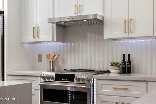 kitchen with white cabinets, light stone counters, tasteful backsplash, under cabinet range hood, and stainless steel electric stove