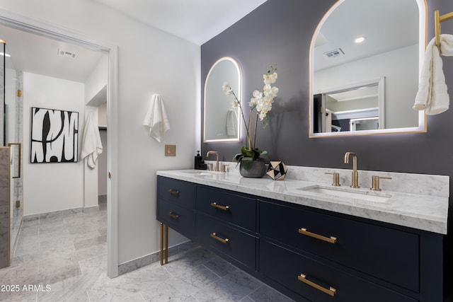 bathroom with baseboards, visible vents, and a sink