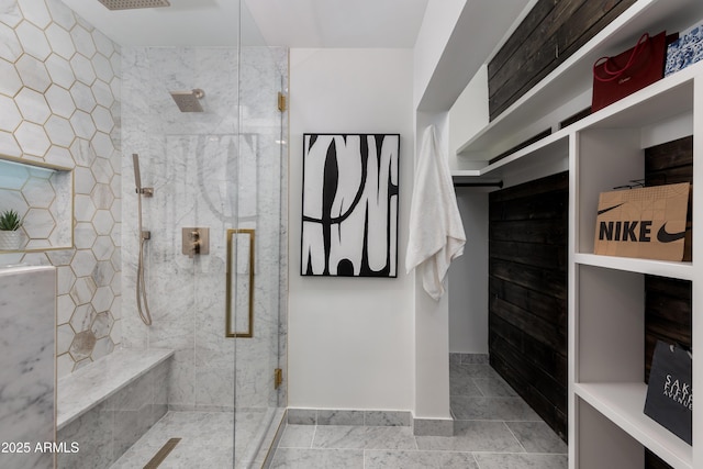 full bath with baseboards, a shower stall, and tile patterned flooring