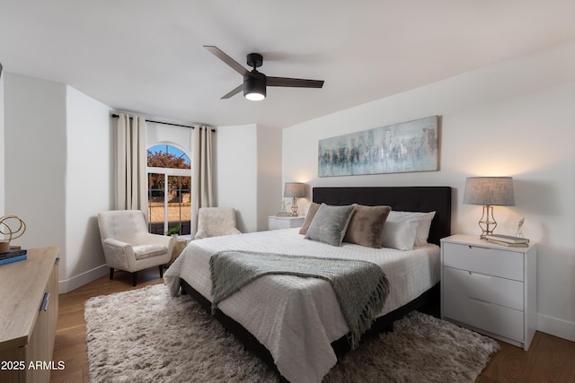 bedroom with baseboards, a ceiling fan, and wood finished floors