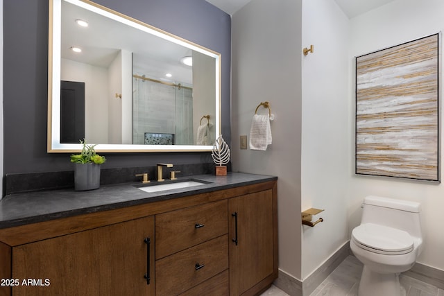 bathroom featuring vanity, baseboards, toilet, a shower with door, and recessed lighting