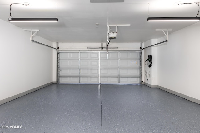 garage with baseboards and a garage door opener