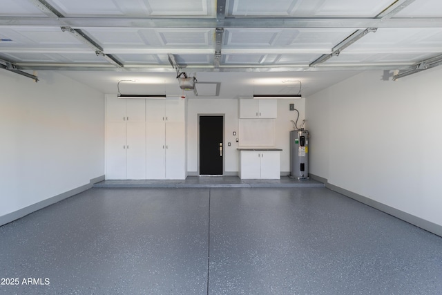 garage featuring baseboards, a garage door opener, and electric water heater