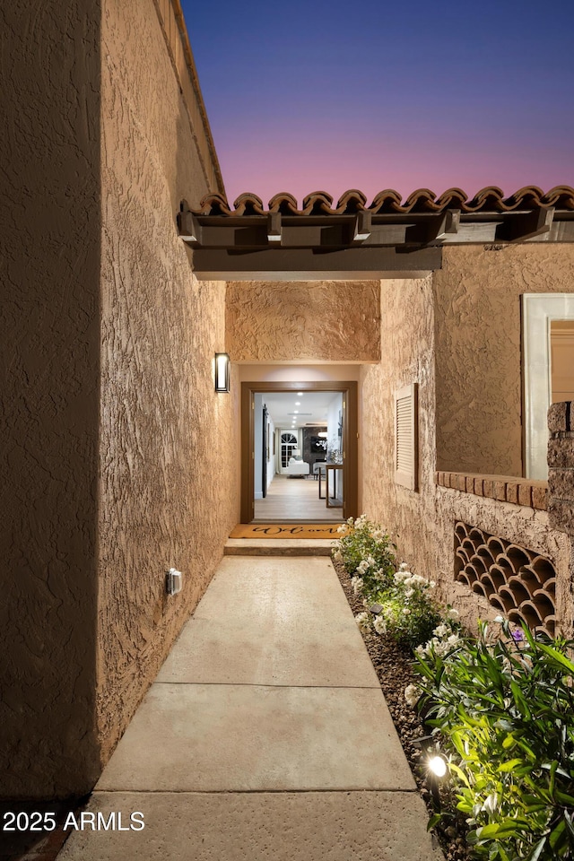 property entrance featuring stucco siding