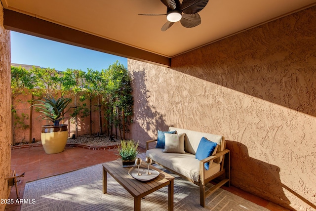 view of patio featuring fence, a ceiling fan, and outdoor lounge area