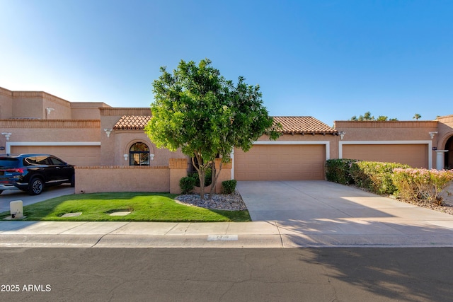 view of front of property with a garage, stucco siding, a tiled roof, and driveway