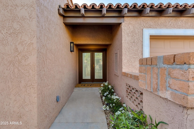 entrance to property with french doors and stucco siding