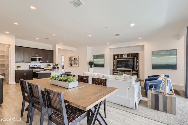 dining space with recessed lighting, visible vents, and light wood-style flooring