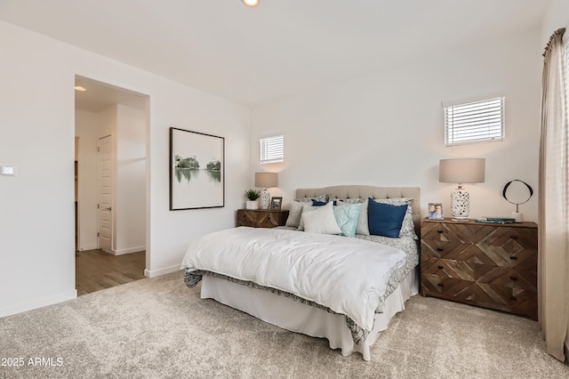 bedroom with light carpet and baseboards