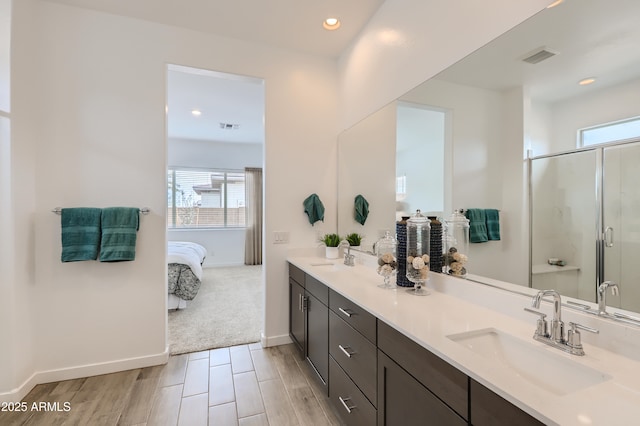 ensuite bathroom featuring a healthy amount of sunlight, a sink, visible vents, and ensuite bathroom