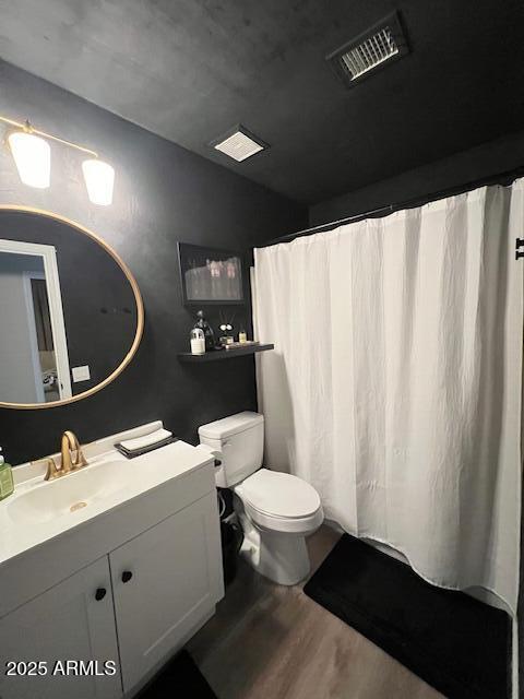 bathroom featuring hardwood / wood-style flooring, vanity, and toilet