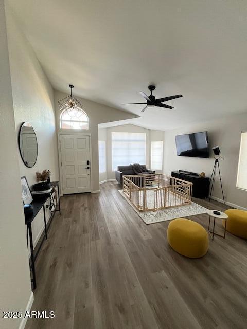 foyer featuring lofted ceiling, dark hardwood / wood-style floors, and ceiling fan