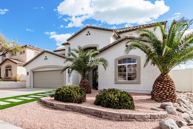 mediterranean / spanish house featuring a garage, a tile roof, driveway, and stucco siding