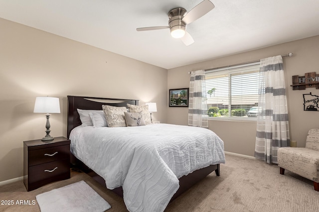 carpeted bedroom featuring baseboards and ceiling fan