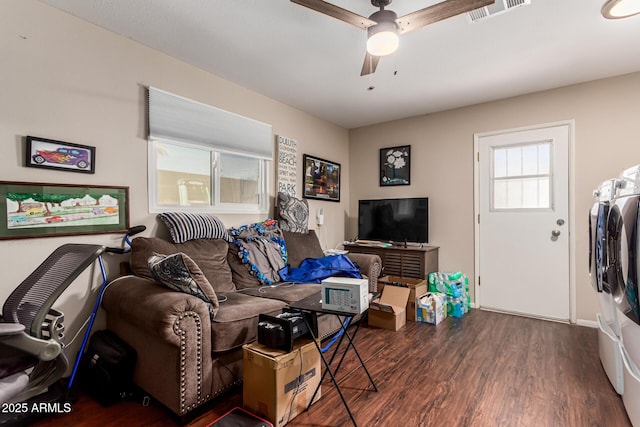 living area featuring wood finished floors, visible vents, ceiling fan, and separate washer and dryer