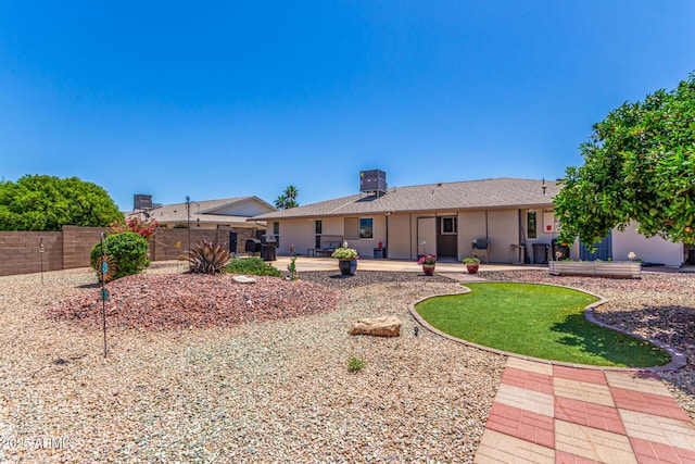 back of house featuring fence, cooling unit, a patio area, and stucco siding