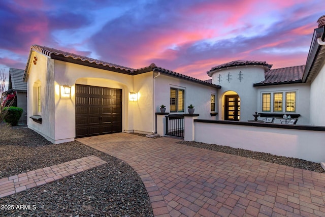 mediterranean / spanish house featuring a garage