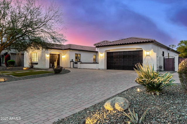 mediterranean / spanish home with a garage