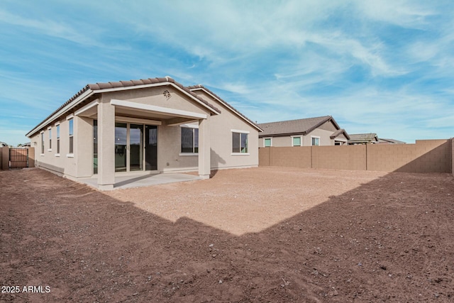 rear view of property featuring a patio