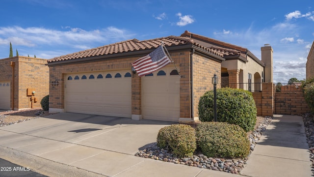 view of front of home featuring a tile roof, brick siding, an attached garage, fence, and driveway