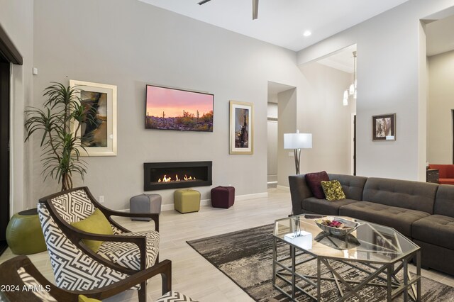 living room with light wood-type flooring and ceiling fan