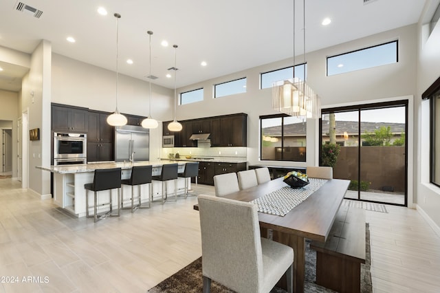 dining area with sink and a high ceiling