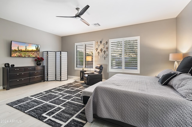 bedroom with ceiling fan and light wood-type flooring