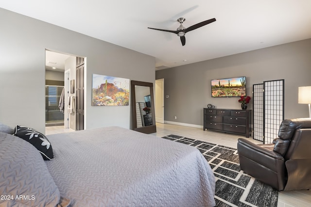 bedroom with light hardwood / wood-style flooring, ensuite bath, and ceiling fan