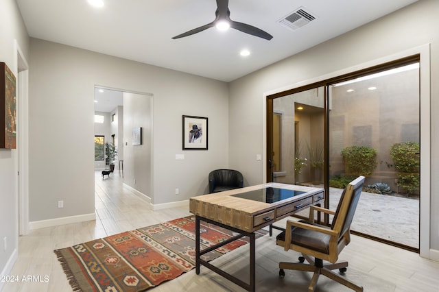 office featuring ceiling fan and light hardwood / wood-style flooring