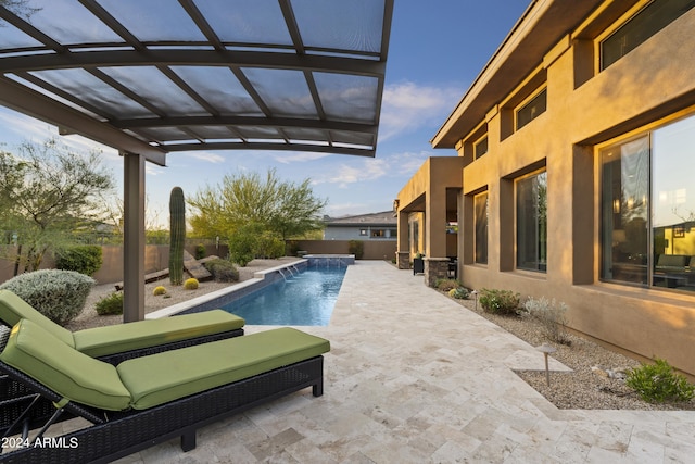 view of swimming pool featuring pool water feature and a patio