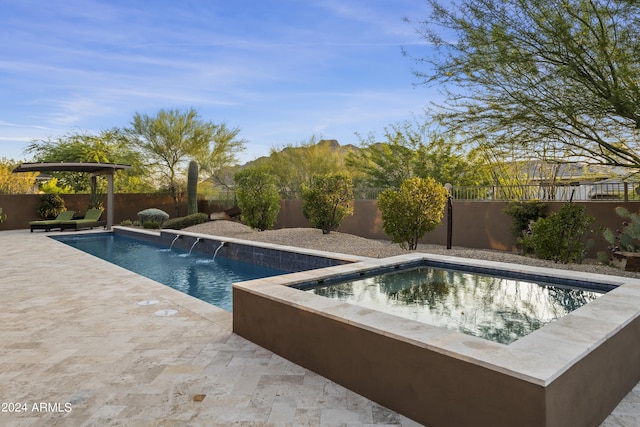 view of swimming pool with pool water feature, a patio, and a hot tub