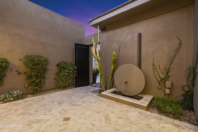 view of patio terrace at dusk