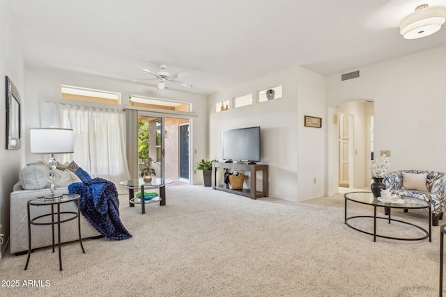 carpeted living room featuring ceiling fan