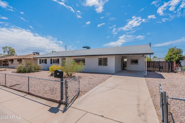 single story home featuring a carport