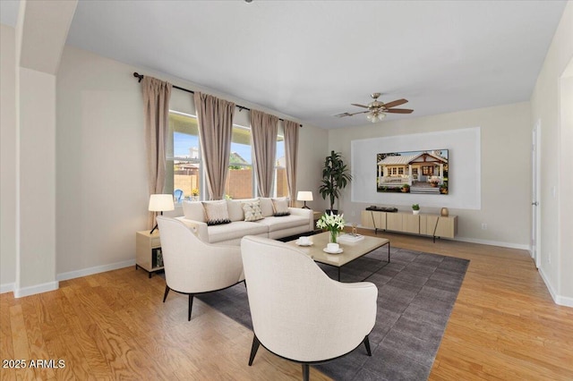 3784 E Washington Ct, Gilbert, AZ 85234 - living room featuring radiator heating unit, a ceiling fan, light wood-style floors, and baseboards
