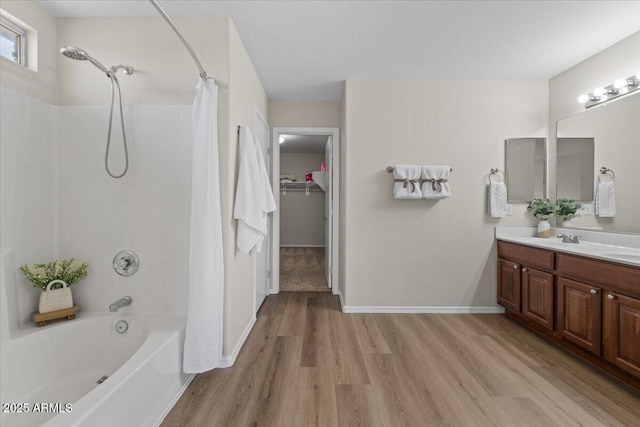 3784 E Washington Ct, Gilbert, AZ 85234 - full bathroom with wood finished floors, shower / bath combination with curtain, vanity, a spacious closet, and baseboards
