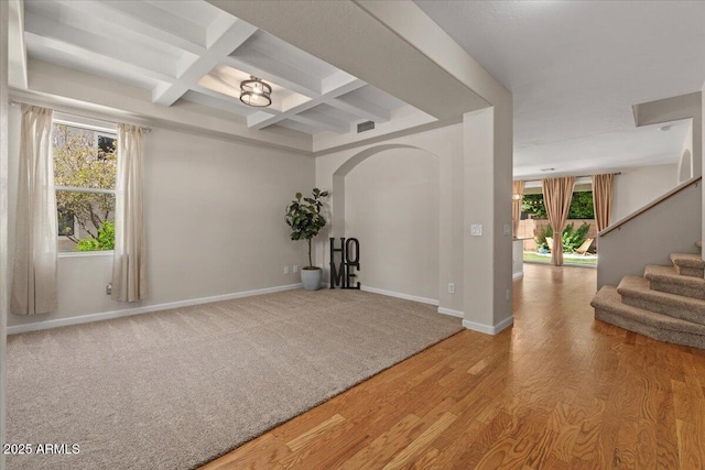 3784 E Washington Ct, Gilbert, AZ 85234 - empty room featuring coffered ceiling, arched walkways, beam ceiling, stairway, and light wood-style floors