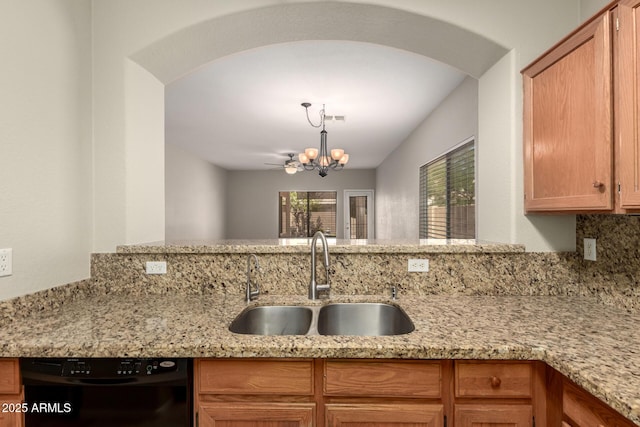 20632 N 103rd Ave, Peoria, AZ 85382 - kitchen featuring black dishwasher, a chandelier, light stone counters, arched walkways, and pendant lighting