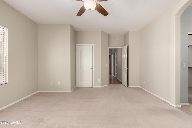 20632 N 103rd Ave, Peoria, AZ 85382 - unfurnished bedroom with light colored carpet, arched walkways, and ceiling fan
