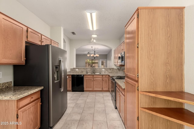 20632 N 103rd Ave, Peoria, AZ 85382 - kitchen featuring stainless steel appliances, a chandelier, light stone counters, light tile patterned floors, and arched walkways