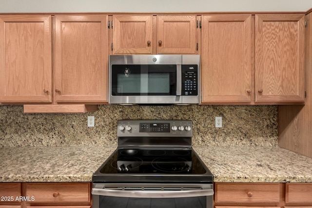 20632 N 103rd Ave, Peoria, AZ 85382 - kitchen featuring appliances with stainless steel finishes, backsplash, light brown cabinetry, and light stone countertops