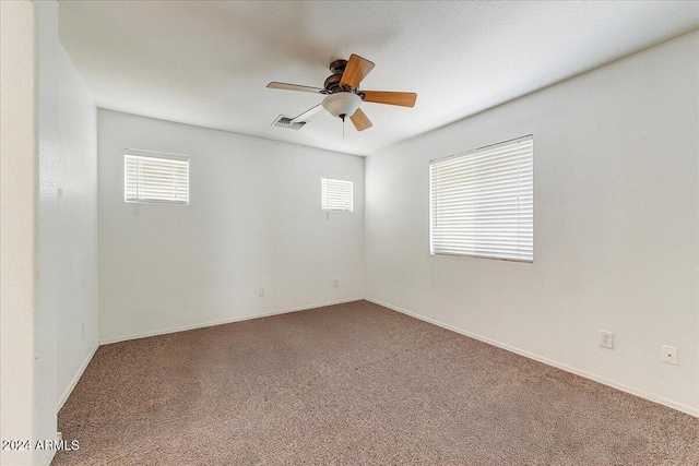 empty room featuring carpet flooring, plenty of natural light, and ceiling fan