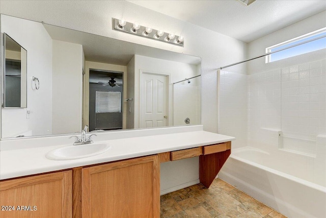 bathroom featuring a textured ceiling, vanity, shower / washtub combination, and ceiling fan