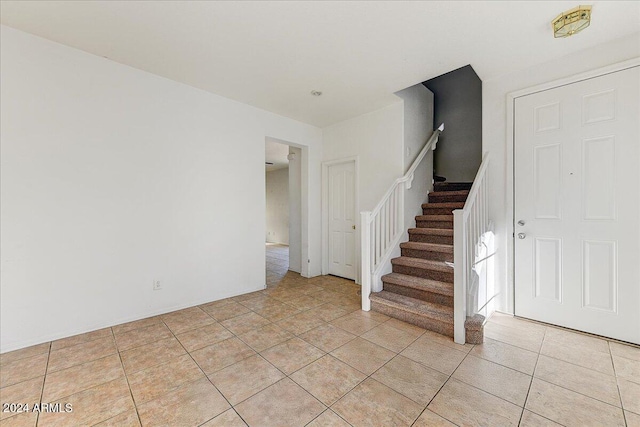 staircase featuring tile patterned flooring