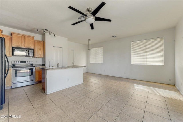 kitchen featuring black appliances, a center island with sink, ceiling fan, decorative light fixtures, and light tile patterned flooring