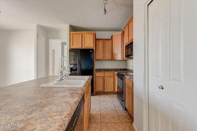 kitchen featuring light tile patterned floors, sink, a textured ceiling, and black appliances