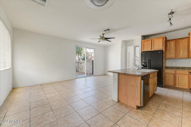 kitchen featuring a center island with sink, ceiling fan, stainless steel dishwasher, and light tile patterned floors