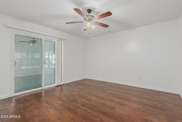 empty room with ceiling fan, dark hardwood / wood-style floors, and a textured ceiling